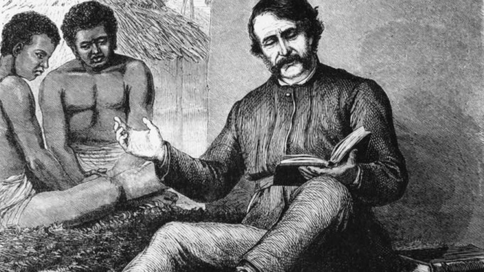 Holzstich: David Livingstone liest Afrikanern aus einem Buch vor.