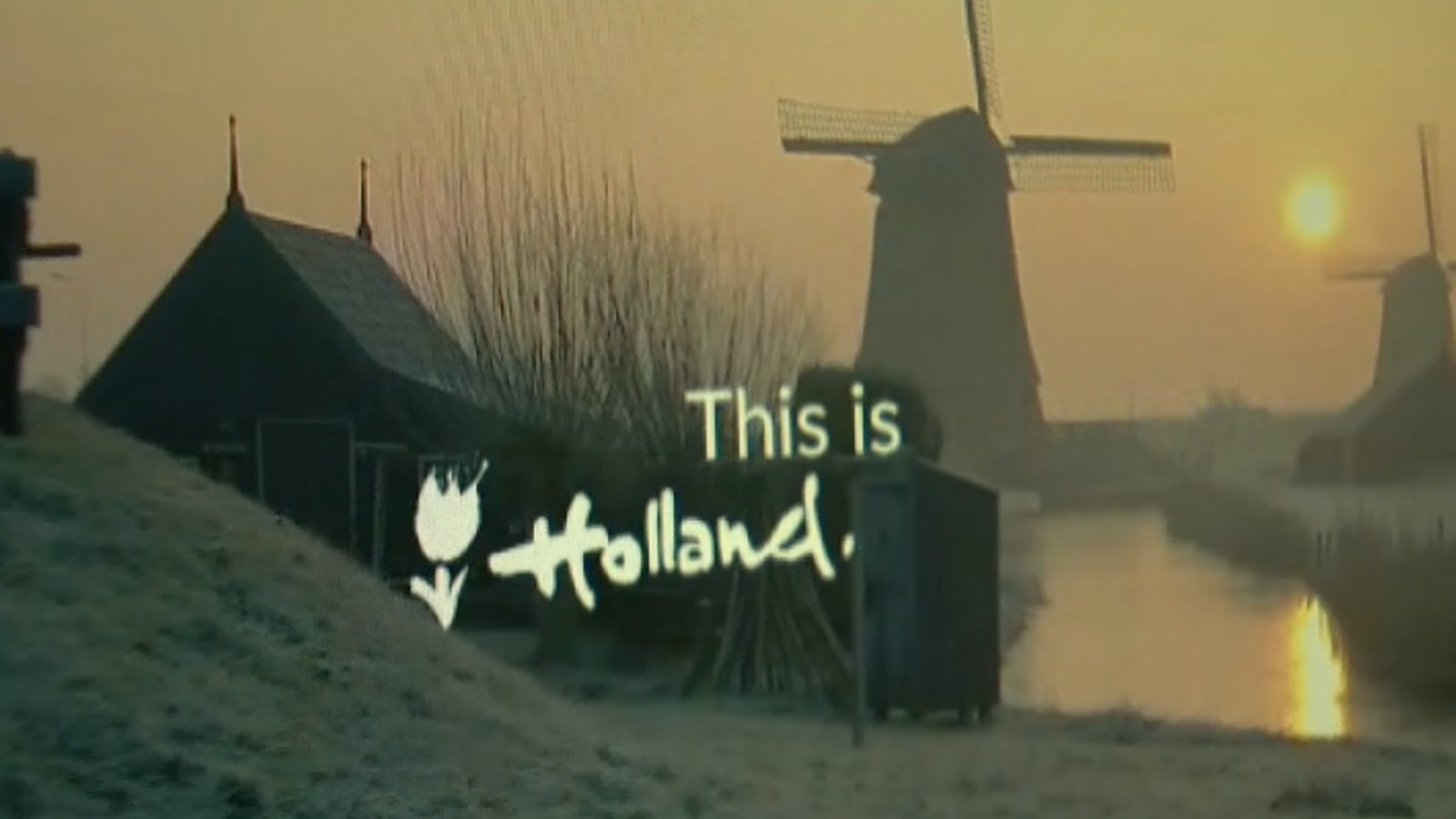 Werbeanzeige mit einer Windmühle in der Dämmerung und dem Schriftzug "This is Holland"