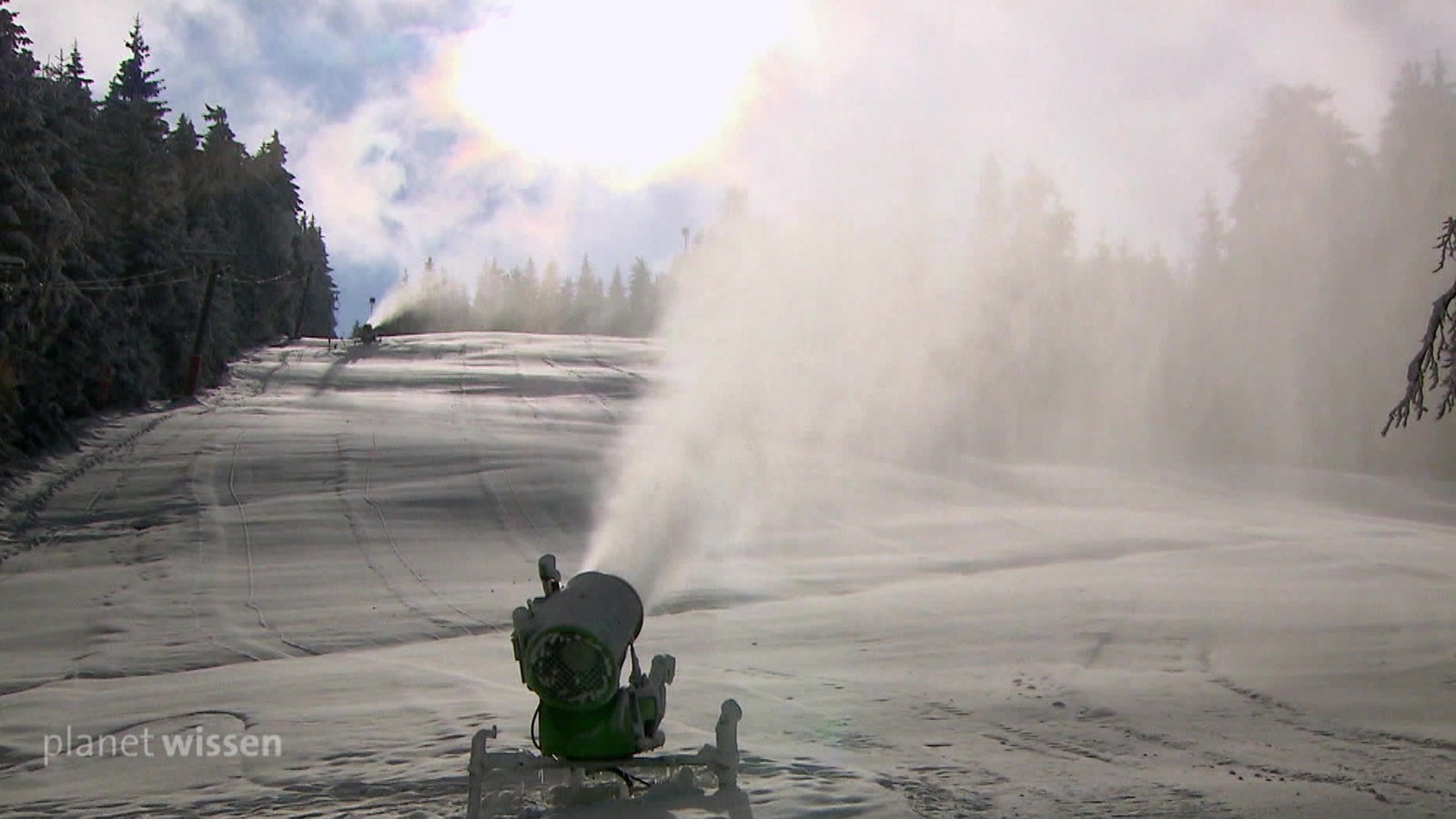 Schneekanonen beschneien eine Skipiste